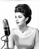 Young woman singing into a microphone poster print