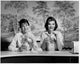 Portrait of Two Young Women Sitting in a Restaurant Poster Print