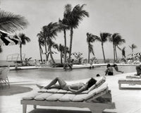 Bahamas Poolside Relaxation Poster Print featuring a young woman lounging by the pool.