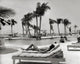 Bahamas Poolside Relaxation Poster Print featuring a young woman lounging by the pool.
