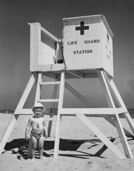 Boy Standing Near a Lifeguard's Chair Poster Print showcasing summer vibes