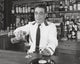 Bartender pouring wine into a wine glass poster print