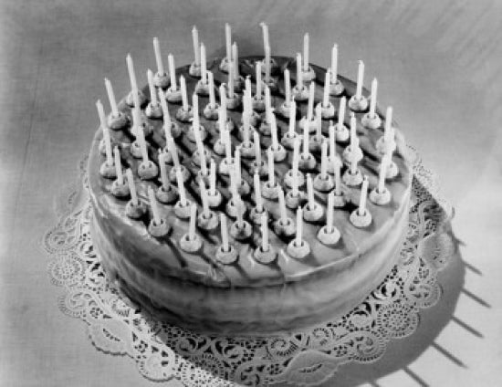 High angle view of a birthday cake decorated with colorful candles.