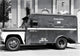 Armored Truck in Front of a Building Poster Print showcasing urban life