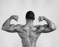 Rear view of a young man flexing his muscles poster print