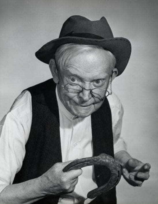 Close-up of a senior man holding a horseshoe poster print