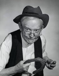 Close-up of a senior man holding a horseshoe poster print