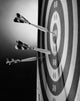 Close-up poster of darts on a dartboard