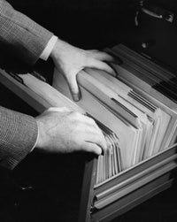 Close-up of a businessman searching for a file poster print.