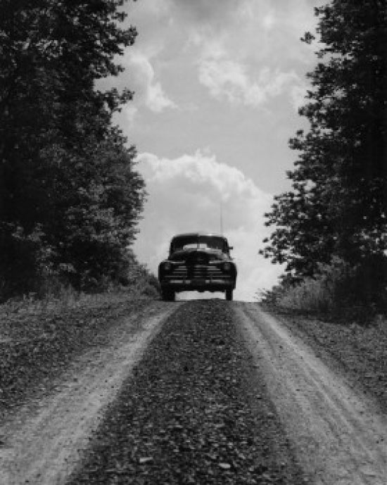 Car Moving on Country Road Poster Print showcasing a scenic landscape.