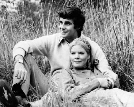 Young couple resting in a field poster print showcasing serenity and romance.