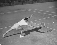 High angle view of a young man playing tennis on a court poster print