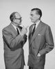 Two Businessmen Talking Poster Print, ideal for office decor.