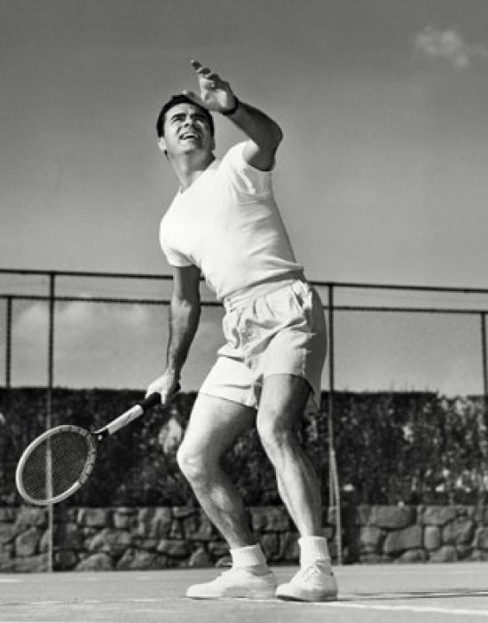 Dynamic tennis action poster print featuring a young man playing tennis from a low angle view.