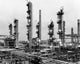Smoke stacks at Tidewater Oil Company poster print showcasing industrial beauty.