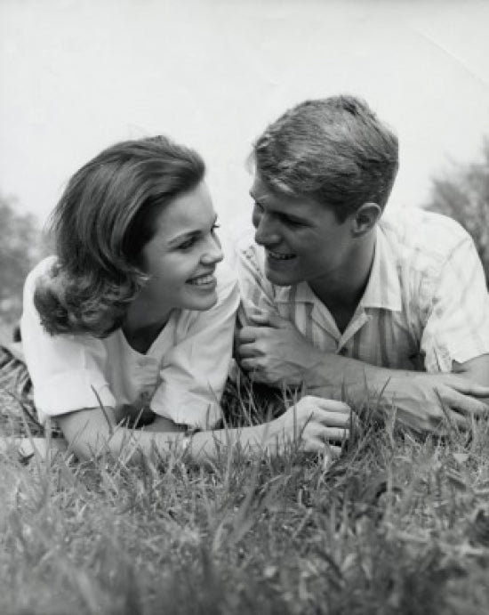 Close-up view of a young couple lying in a park poster print.