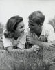 Close-up view of a young couple lying in a park poster print.