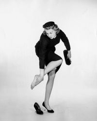 Young Woman Touching Her Ankle Poster Print showcasing elegance and beauty.