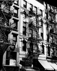 Low angle view of fire escapes on residential buildings in New York City poster print.