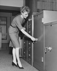 Businesswoman opening a combination lock poster print