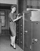 Businesswoman Opening a Combination Lock Poster Print showcasing empowerment and success.