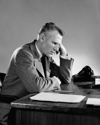 Contemplative businessman at a desk poster print