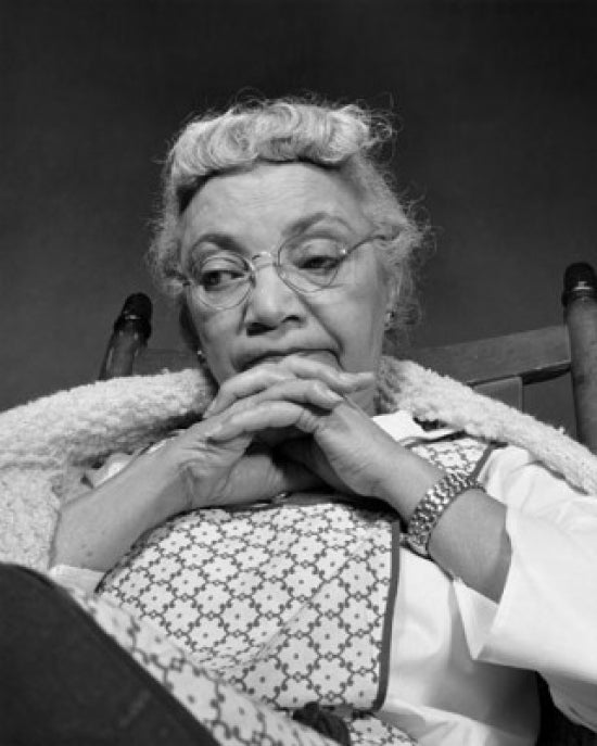 Close-up poster print of a senior woman looking pensive, showcasing emotional depth.