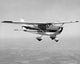 Airplane in flight poster print showcasing an aircraft soaring through the sky.