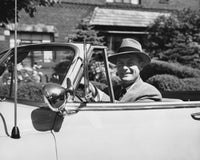 Businessman smiling in a car poster print, inspiring confidence and success.