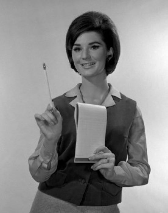 Studio portrait of a secretary holding a notepad poster print.