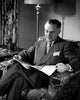 Man Reading Newspaper in Armchair Poster Print