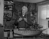 Senior man building a model ship poster print