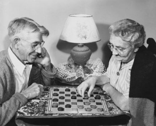 Senior Couple Playing Checkers Poster Print