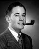 Studio portrait of a young man smoking a tobacco pipe, vintage art print.
