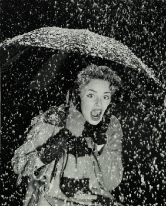Young women holding an umbrella in the snow poster print