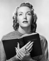 Close-up poster of a young woman holding the Bible, showcasing serenity and spirituality.