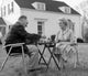 Senior couple enjoying a board game in their backyard, poster print.