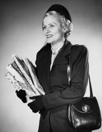 Close-up poster print of a mid-adult woman carrying Christmas presents, festive decor.