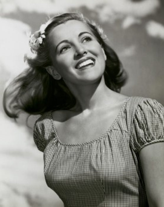 Close-up poster print of a young woman smiling.