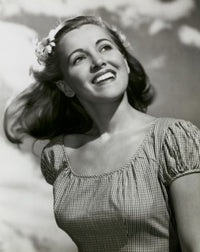 Close-up poster print of a young woman smiling.