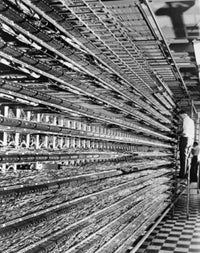 Technicians working on a distributing frame in a telephone network control room poster print