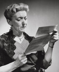 Senior woman reading a document poster print