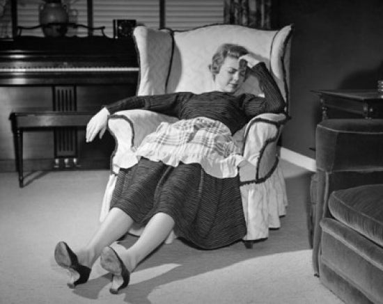 Mid adult woman peacefully sleeping on an armchair poster print.