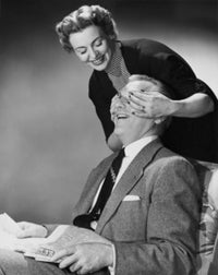 Mid adult woman covering the eyes of a mid adult man poster print
