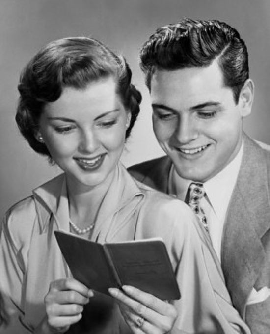 Close-up of a young couple holding a bank book poster print.