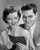 Close-up of a young couple holding a bank book poster print.
