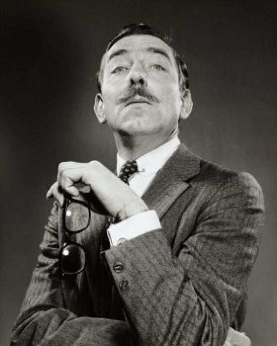 Portrait of a mature man holding eyeglasses poster print.