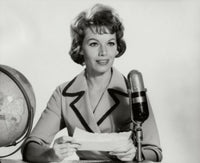 Mid adult woman reading a report into a microphone poster print