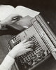 Close-up poster of a person operating a calculator