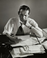 High angle view of a businessman reading documents in an office poster print.